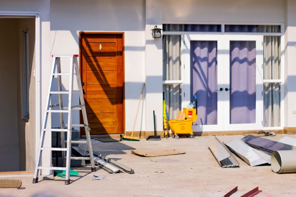 EIFS repair with flashing materials and ladder at a stucco home